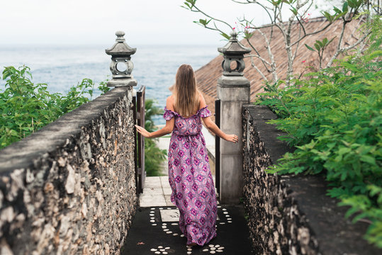 Young woman walking down  to sea