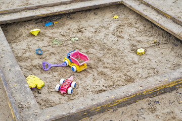Children wooden sand box with some plastic toys