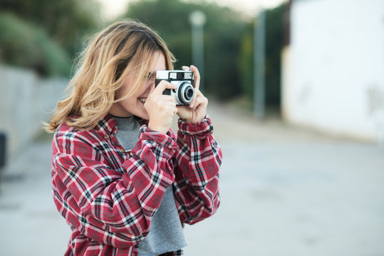 Smiling Girl Taking Shot With Film Camera.