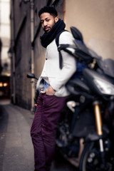 Fototapeta na wymiar Young Black Man And His Motorcycle In Paris