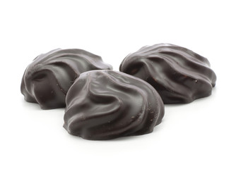 Three dark chocolate-coated zefir isolated on white background.