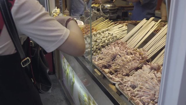 Chinese people buying BBQ seafood