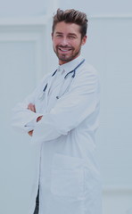 Portrait of confident male doctor with arms crossed standing