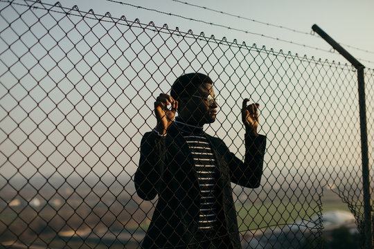 African man behind an iron grid