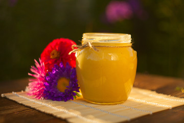 Delicious delicious honey in  jar on table