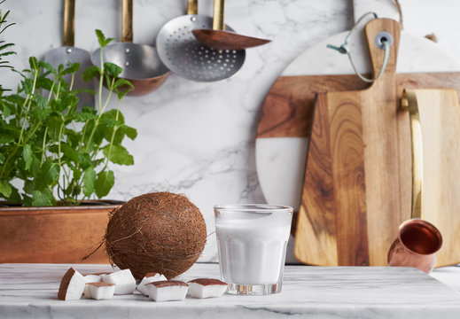 Whole Coconut,raw Coconut Chunks And Coconut Cream On A Kitchen Work Surface.