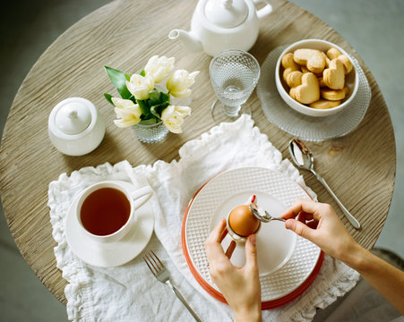 The person cracking an egg