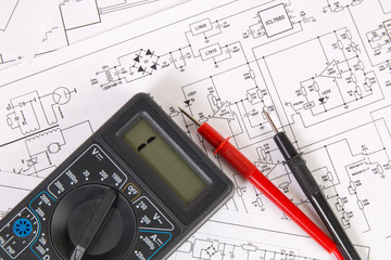 Electronics and Engineering. Printed drawings of electrical circuits and digital multimeter. Science, technology and electronics.