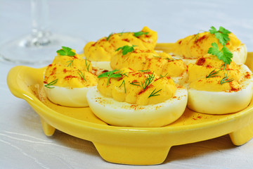 Deviled eggs on yellow serving plate