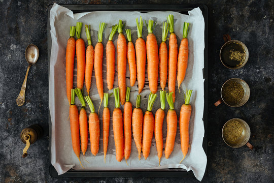 Fresh carrots with herbs ready to be oven roasted