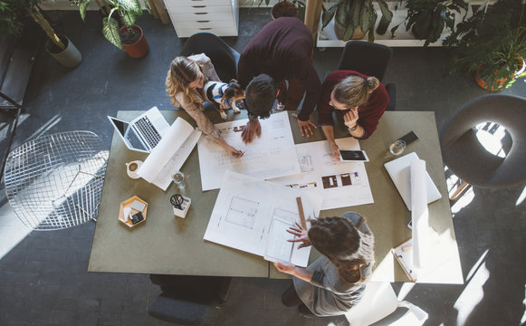 Businesspeople Working With Technical Drawing