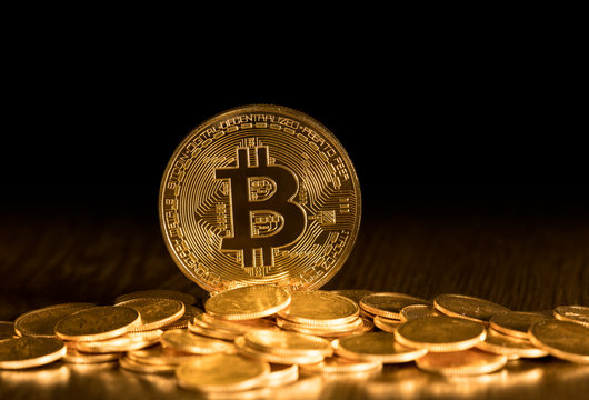 Stack of bitcoins with gold background