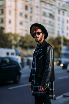 Man wearing black leather jacket and hat