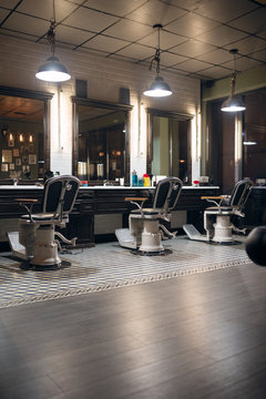 Barber chairs in front of the mirror in barbershop