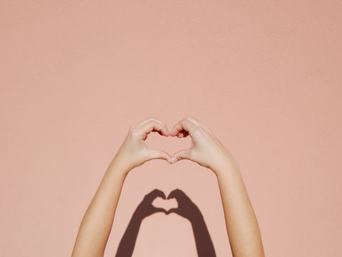 Hands making a heart sign.