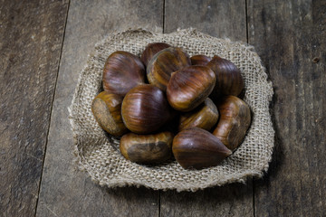 Tins and baking forms on a wooden table. Old kitchen accessories on the kitchen table. black background.