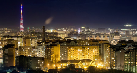 Fototapeta na wymiar Panorama of night aerial view of Ivano-Frankivsk city, Ukraine with bright lights and high buildings.