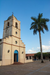 Fototapeta na wymiar Church of vinales and palm at sunset