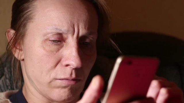 Woman busy using smart phone, close-up, selective focus with shallow depth of field.
