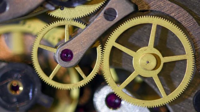 Clock or stopwatch mechanism close-up. Rotating action of watch gear cogwheels