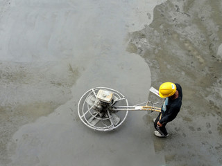 Power float works by construction workers at the construction site. Power float machine was used to...