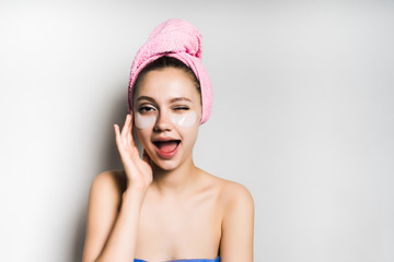 smiling girl with a towel on her head winking looking forward