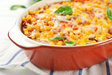 Baking dish with corn pudding on table, closeup