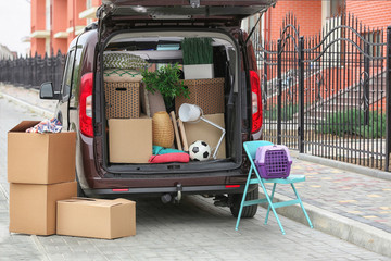 Cardboard boxes in car trunk on moving day