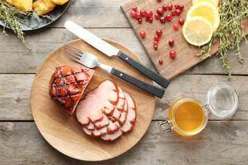 Dish with traditional sliced honey baked ham on table