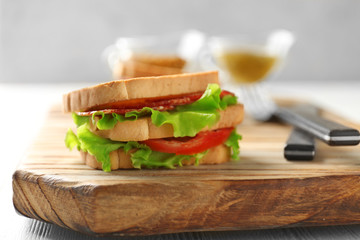 Delicious sandwich on wooden board, closeup