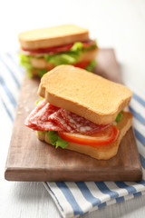 Delicious sandwich on wooden board, closeup
