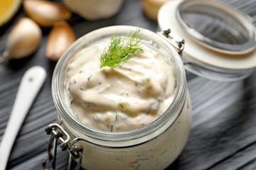 Tasty sauce with garlic in jar, closeup
