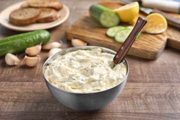 Tasty sauce with garlic in bowl on wooden table © Africa Studio
