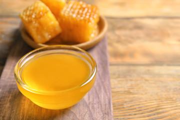 Glass bowl with honey on table, closeup