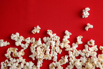 Tasty popcorn on red background, top view