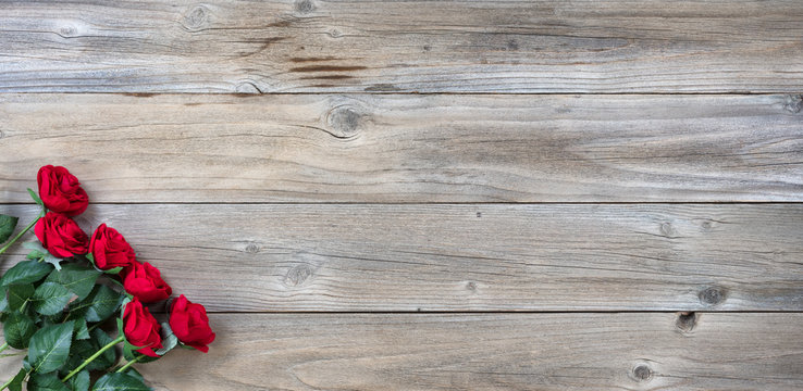 traditional red roses on rustic wooden background