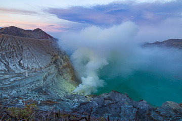 Sunrise at Kawah Ijen volcano crater with sulfur fume. Ijen crater the famous tourist attraction near Banyuwangi, East Java, Indonesia