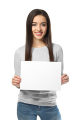 Naklejka premium Young woman with blank sheet of paper for advertising on white background
