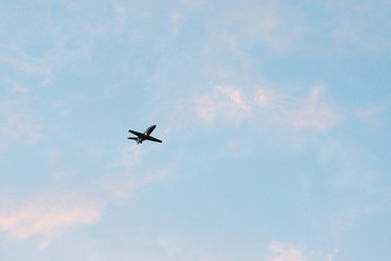 Commercial airplane flying at sunset sky