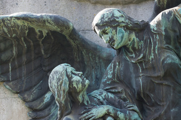Statue of a celestial being/ Angel looking upon a human. Dresden, Grmany, Johannisfriedhof