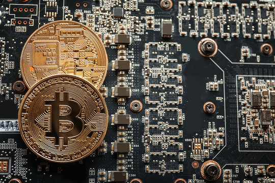 Golden bitcoins on circuit board