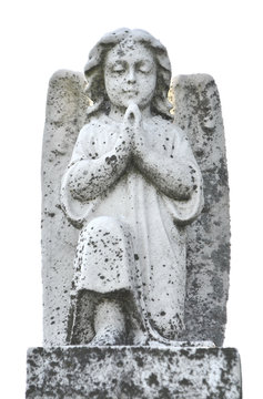 Vintage image of a sad angel on a cemetery. Weathered angelic cherub sculpture with wings. Angel guardian.