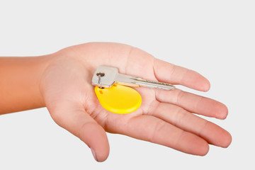 key with a round yellow key chain pendant on the female palm