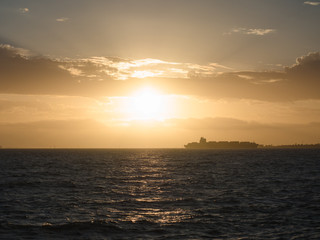 A ship passes as the sun sets in Melbourne, Australia.
