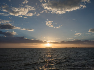 A ship passes as the sun sets in Melbourne, Australia.
