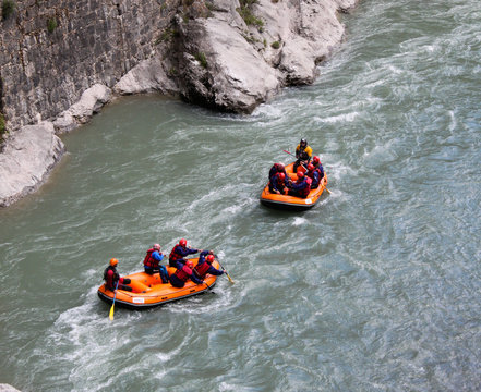 Rafting in a river of Huesca, Spain. Rafting at Tara mountain river. Group of tourists in the inflatable raft