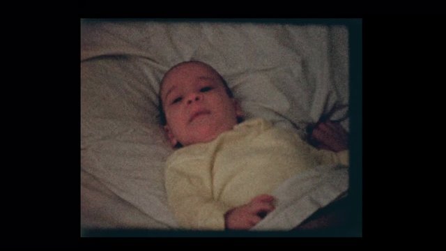 1959 2 month old infant boy in big brothers bed