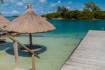 Table and a parasol in a water at Caye Caulker island, Belize