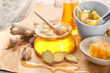 Composition with honey and garlic as natural cold remedies on table