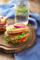 Delicious sandwich on wooden board